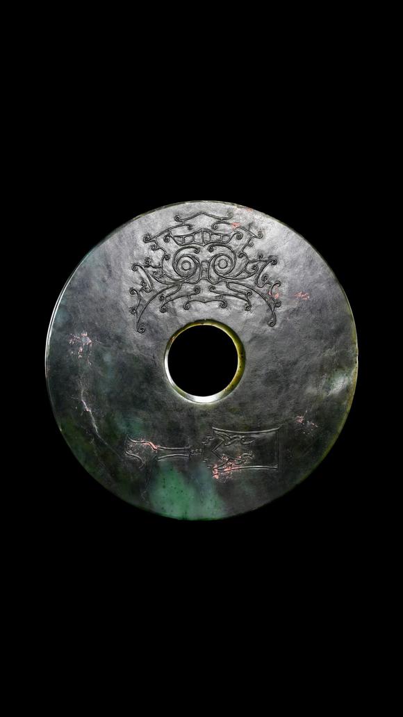 Castle AuctionA Dark Green Jade Bi Disc with Incised Decoration, Neolithic, Circa 3300–2300 C BC Pr.