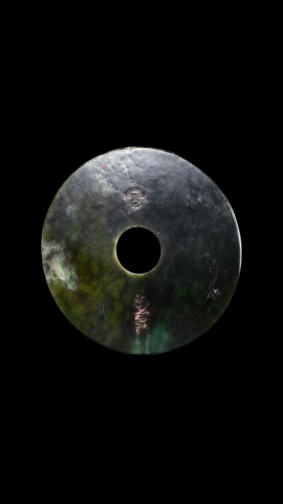 Castle AuctionA Dark Green Jade Bi Disc with Incised Decoration, Neolithic, Circa 3300–2300 C BC Pr.