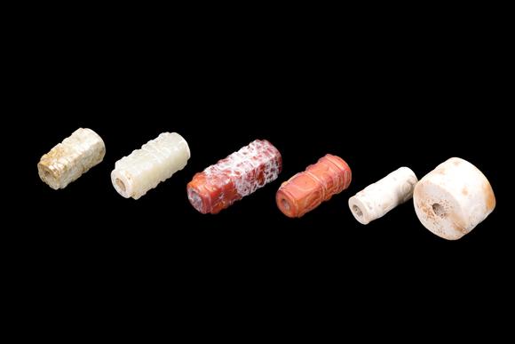 Castle AuctionA Group of Six Calcified & Reddish Jade Cong-Style Beads, Liangzhu, Circa 3300–2300 C BC Pr.