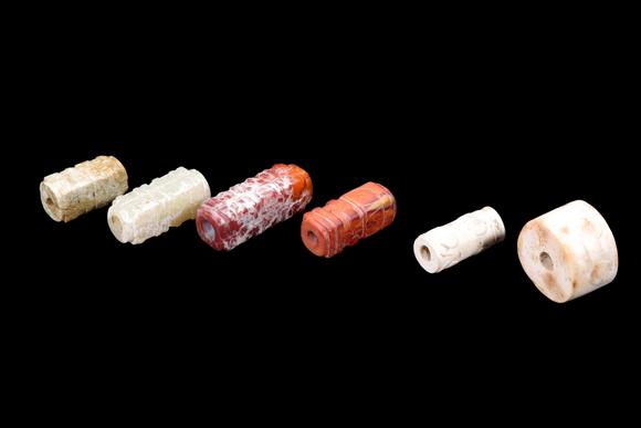Castle AuctionA Group of Six Calcified & Reddish Jade Cong-Style Beads, Liangzhu, Circa 3300–2300 C BC Pr.