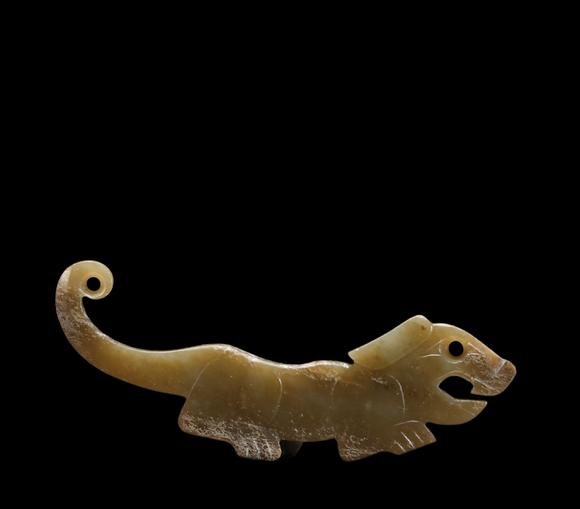 Castle AuctionA Calcified Yellow Jade Tiger-form Pendant, Western Zhou, Circa 10th–9th C BC Pr.
