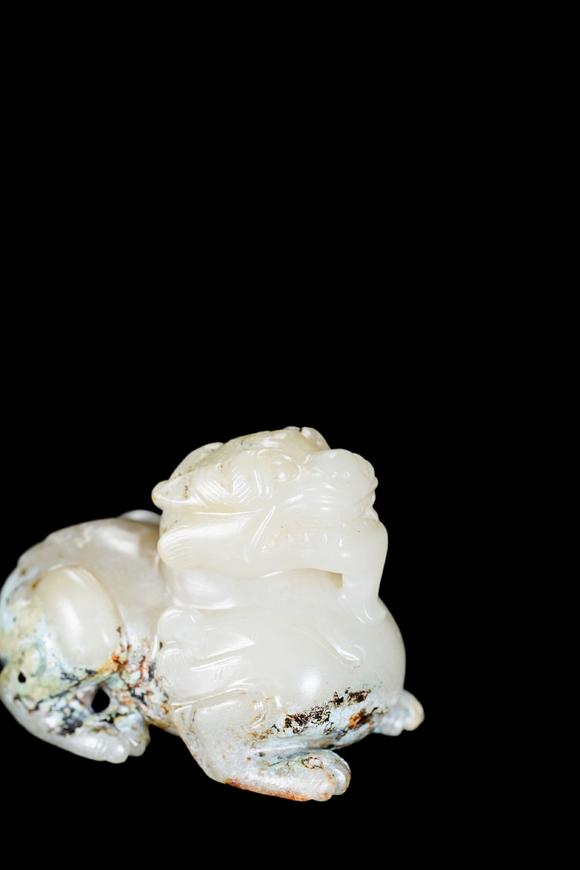Castle AuctionA Pale Celadon Jade Mythical Beast Carving, Han, Circa 2nd C BC–2nd C AD Pr.