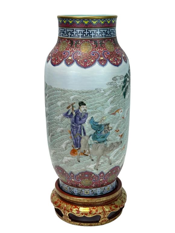 Castle AuctionA Chinese Rouge Famille Rose vase adorned with the Eight Immortals' figures pattern, together with A Chinese porcelain stand, Qian Long Pr. 
