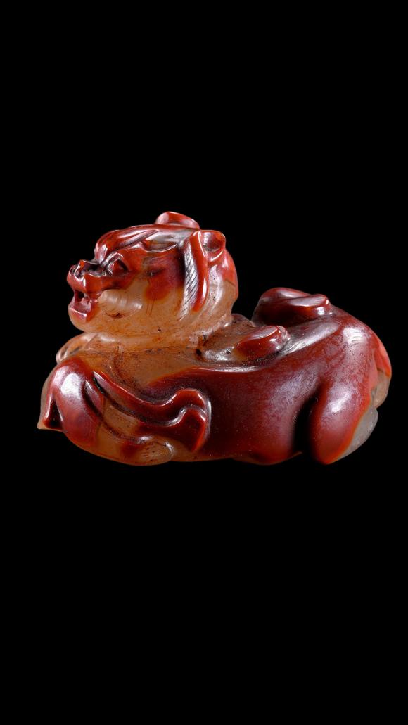 Castle AuctionA Reddish Jade Mythical Beast Carving, Han, Circa 2nd C BC–2nd C AD Pr.