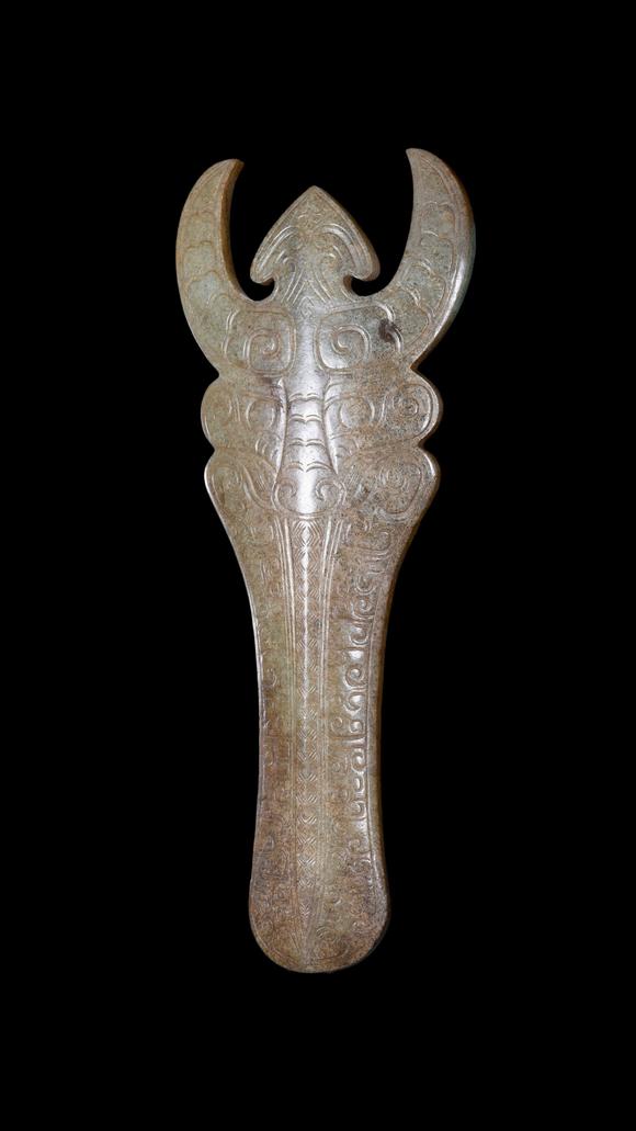 Castle AuctionA Calcified Pale Jade Ox-Headed Plaque, Western Zhou, Circa 10th–9th C BC Pr.
