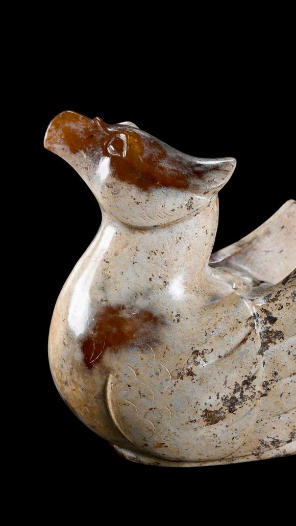 Castle AuctionA Calcified White Jade Phoenix Carving with Russet Inclusions, Han, Circa 2nd C BC–2nd C AD Pr.