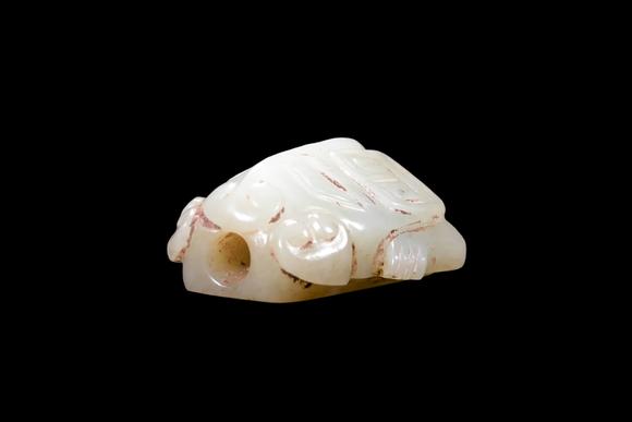 Castle AuctionA Pale Celadon Jade Taotie Mask Bead, Shang, Circa 13th–11th C BC Pr.