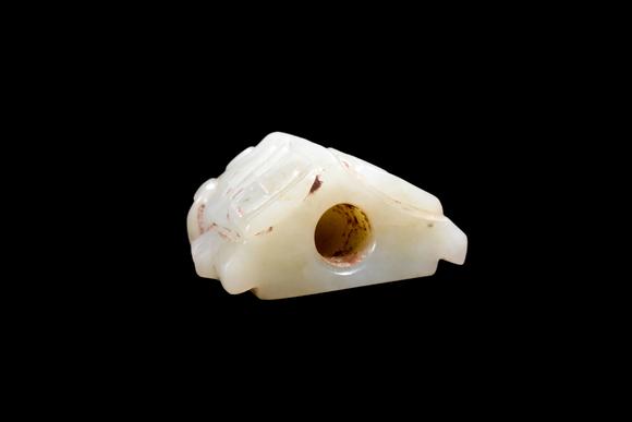 Castle AuctionA Pale Celadon Jade Taotie Mask Bead, Shang, Circa 13th–11th C BC Pr.