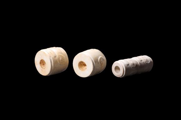 Castle AuctionA Three Calcified White Jade Human-Face Beads, Liangzhu, Circa 3300–2300 C BC Pr.