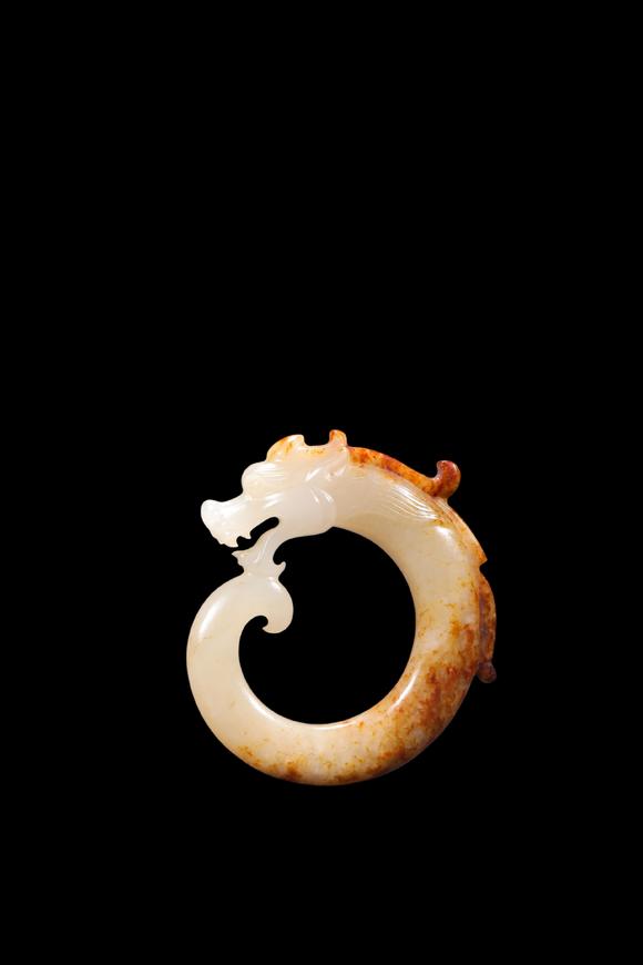 Castle AuctionA White Jade C-Shaped Dragon Pendant with Russet Veins, Han, Circa 2nd C BC–2nd C AD Pr.