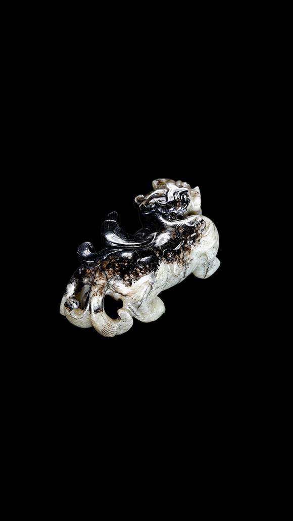 Castle AuctionA Mottled Black & White Jade Crouching Tiger Carving, Han, Circa 2nd C BC–2nd C AD Pr.