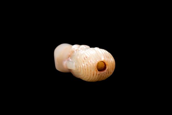 Castle AuctionA Pale Jade Human Head Bead with Russet Inclusions, Shang, Circa 13th–11th C BC Pr.
