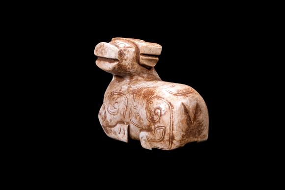 Castle AuctionA Calcified Pale Jade Recumbent Ox Carving, Shang, Circa 13th–11th C BC Pr.