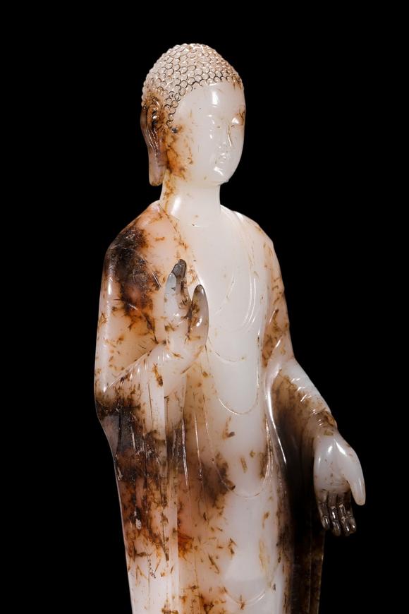 Castle AuctionA White Jade Standing Buddha Statue with Russet Inclusions, Tang, Circa 618–907 AD Pr.