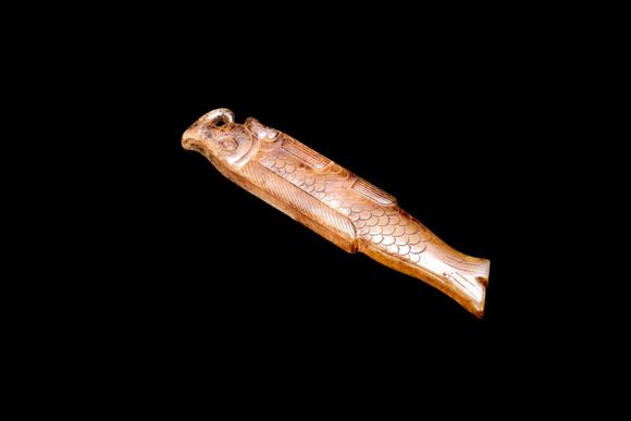 Castle AuctionA Calcified Yellow Jade Fish Pendant, Shang, Circa 13th–11th C BC Pr.
