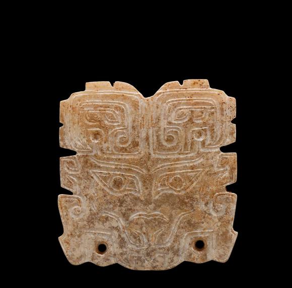 Castle AuctionA Calcified Brown Jade Taotie Mask Pendant, Western Zhou, Circa 10th–9th C BC Pr.