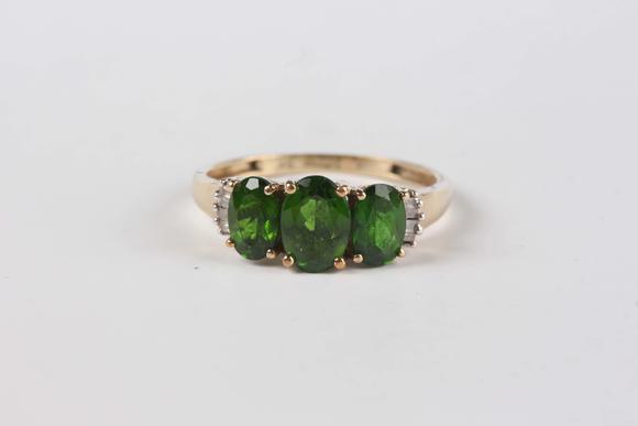 TooveysA 9ct gold ring, claw set with three oval cut green diopsides between baguette cut diamond set shoulders, ring size approx M, and a 9ct gold and colou