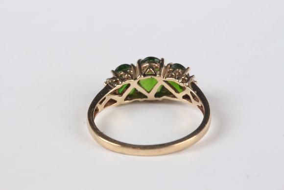 TooveysA 9ct gold ring, claw set with three oval cut green diopsides between baguette cut diamond set shoulders, ring size approx M, and a 9ct gold and colou