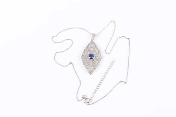 TooveysA platinum, treated sapphire and diamond marquise shaped pendant, collet set with the circular cut sapphire at the centre, length 4.3cm, with a platin