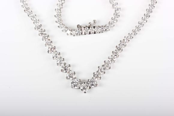 TooveysA white gold and colourless cubic zirconia demi-parure, comprising a graduated necklace and bracelet, each mounted with circular cut colourless cubic