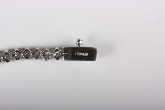 TooveysA white gold and colourless cubic zirconia demi-parure, comprising a graduated necklace and bracelet, each mounted with circular cut colourless cubic