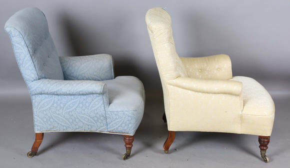 TooveysA near pair of late Victorian Howard & Sons armchairs, each buttoned back above scroll arms, on turned walnut legs with gilt brass caps and castors, e