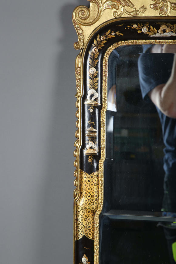 TooveysAn impressive pair of early 20th century Queen Anne style gilt and black japanned pier mirrors, each shaped crest with central shell and griffon heads