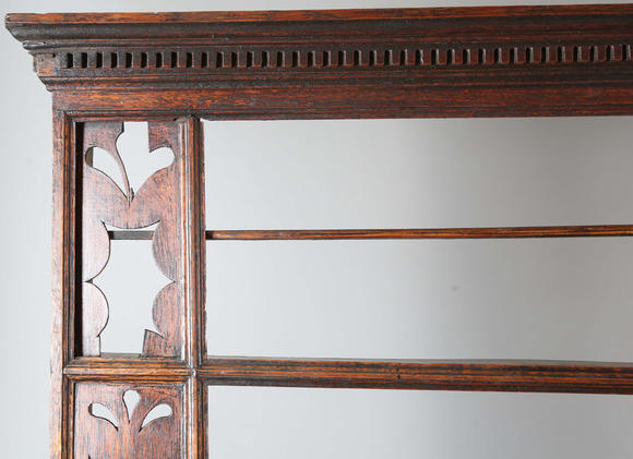 TooveysA good George III North Country oak dresser, the plate rack with pierced side panels above a lappet carved frieze and an arrangement of nine drawers,