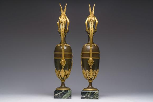 Coronari Auctions BVAn impressive pair of French Empire gilt and patinated bronze ewers on marble bases, attributed to Claude Galle, ca. 1800-1810