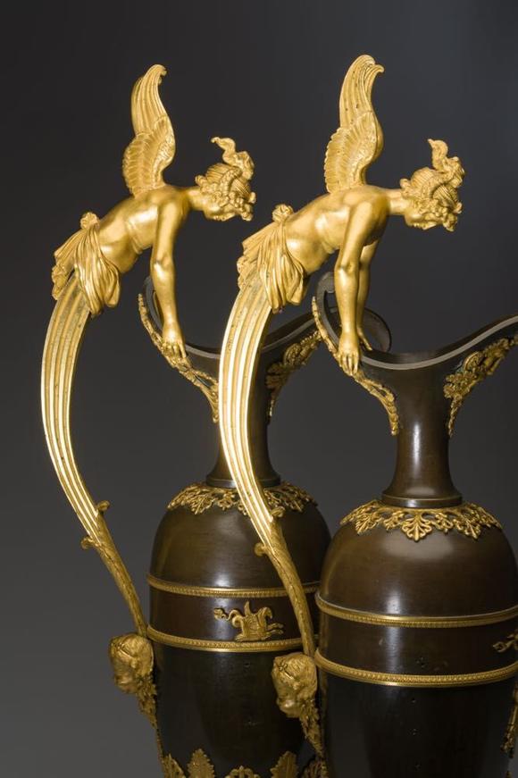 Coronari Auctions BVAn impressive pair of French Empire gilt and patinated bronze ewers on marble bases, attributed to Claude Galle, ca. 1800-1810