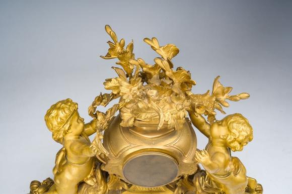 Coronari Auctions BVA fine and exceptional French Napoleon III gilt bronze three-piece clock garniture with putti and floral design, 19th C.