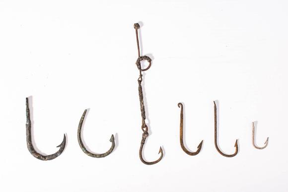 Apollo Art AuctionsCa. 19th century AD. 
A collection of six forged metal fish hooks of varying sizes and forms, wit