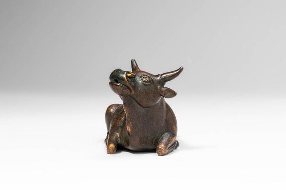 Apollo Art AuctionsMing Dynasty, Ca. AD 1368 - 1644, or earlier. >
A cast bronze figure of a recumbent bull, depicte