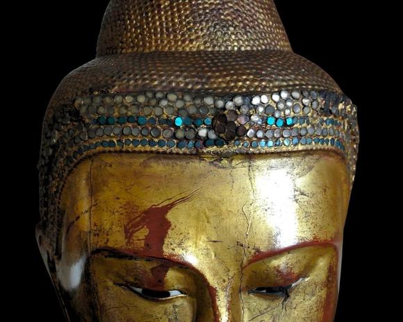 Bertolami Fine ArtBuddha figure in the lotus position. Lacquered and gilded wood with stucco and glass paste applications, set on a wooden and black lacquer base. Burma, Mandalay, 19th century.