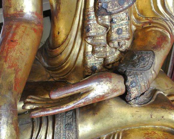 Bertolami Fine ArtBuddha figure in the lotus position. Lacquered and gilded wood with stucco and glass paste applications, set on a wooden and black lacquer base. Burma, Mandalay, 19th century.