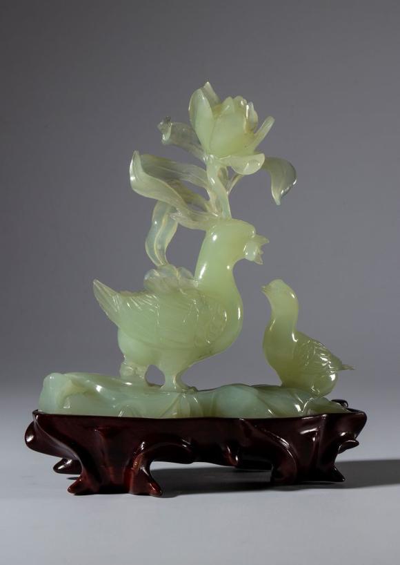 Bertolami Fine ArtGreen jade sculpture on a wooden base depicting a pair of birds and a large flower. China, 20th century.