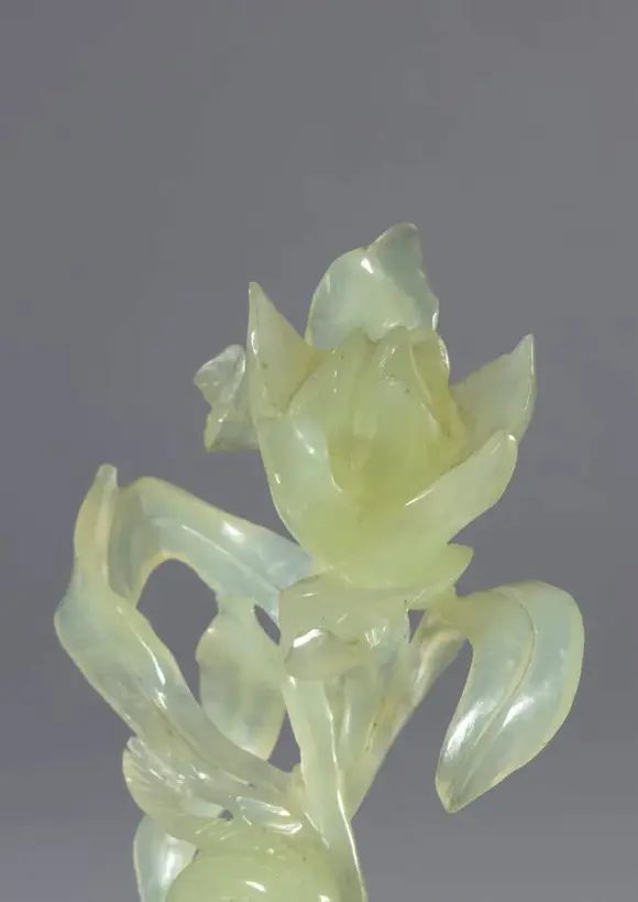 Bertolami Fine ArtGreen jade sculpture on a wooden base depicting a pair of birds and a large flower. China, 20th century.