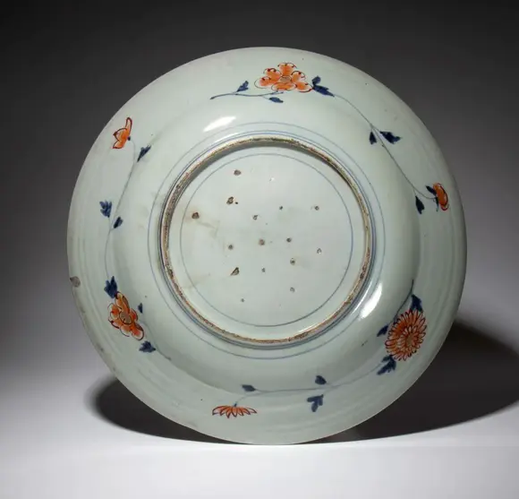 Bertolami Fine ArtLarge plate painted with coral red, blue, and gold enamels. Japan, 18th century.