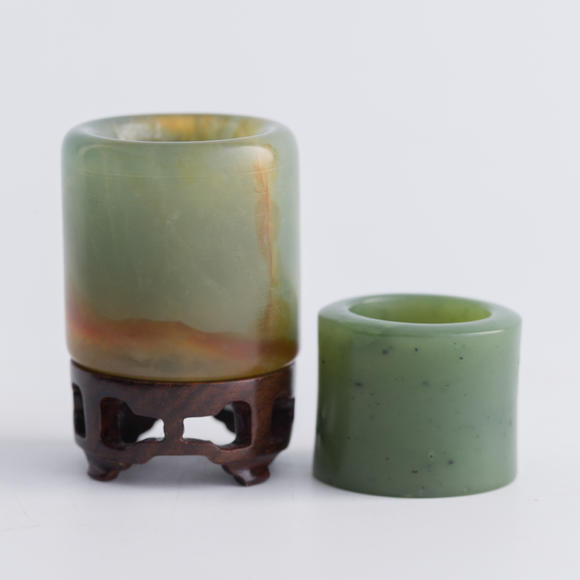 Oakridge Auction Gallery清代 翡翠扳指及碧玉扳指（附木座）  A Chinese jadeite and a spinach jade archer's ring