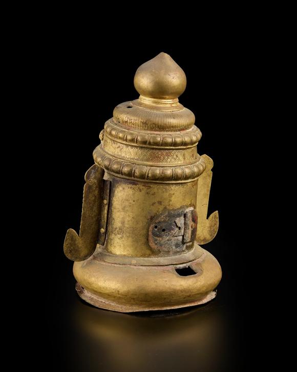 RoseberysA large brass Siva lingam cover,
Western Deccan, 18th-19th century,

with bulging almond eyes, flat nose and full lips, wearing naga-shaped earring