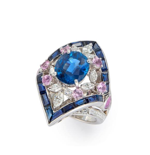 RoseberysA sapphire, diamond and pink sapphire cluster ring, the lozenge shaped cluster with central single oval mixed-cut sapphire in four claw setting, withi
