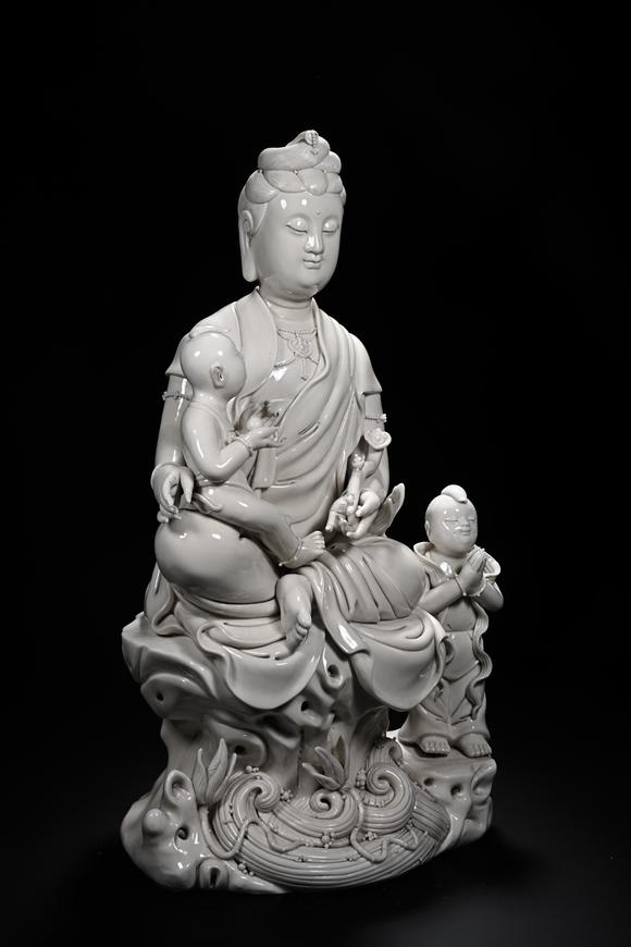 HUNG YUN ZHAI AUCTION HOUSE INCDehua White-Glazed Songzi Guanyin (Bestowing Children)