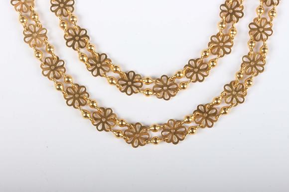 TooveysA gold necklace in a pierced circular and twin bead link design, unm