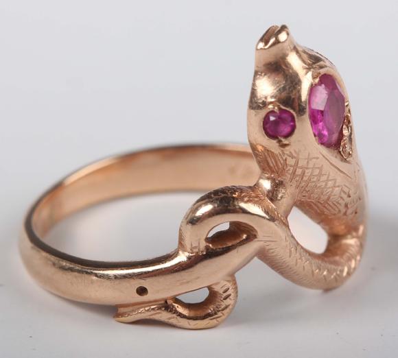 TooveysA gold, ruby and synthetic ruby ring, designed as a coiled snake, de