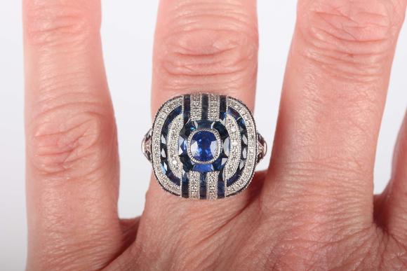 TooveysA platinum, sapphire and diamond panel ring in an Art Deco inspired
