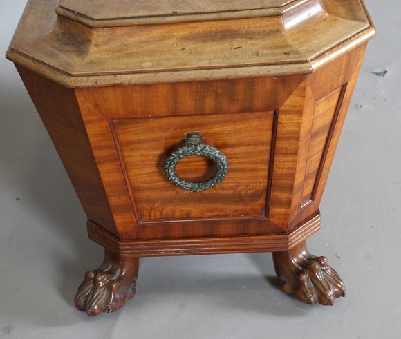 TooveysA George IV mahogany wine cooler of panelled sarcophagus form, the s