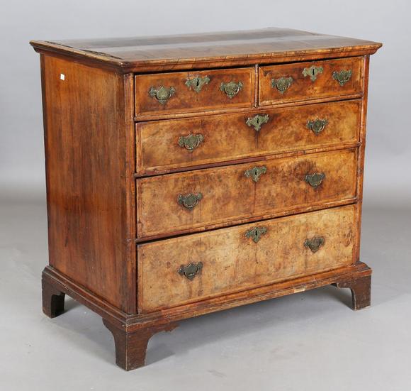 TooveysA George I walnut chest of oak-lined drawers with feather banded bor
