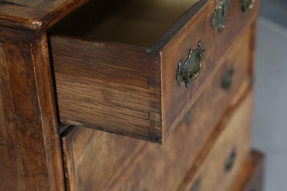 TooveysA George I walnut chest of oak-lined drawers with feather banded bor