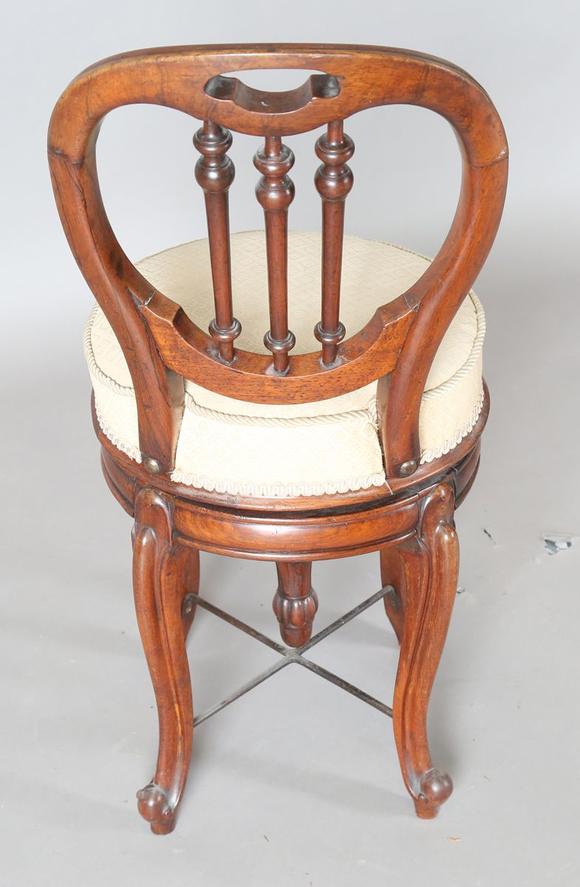 TooveysA Victorian rosewood framed revolving music chair, on cabriole legs,