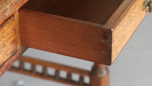 TooveysA late Victorian oak writing table, the top inset with gilt-tooled b